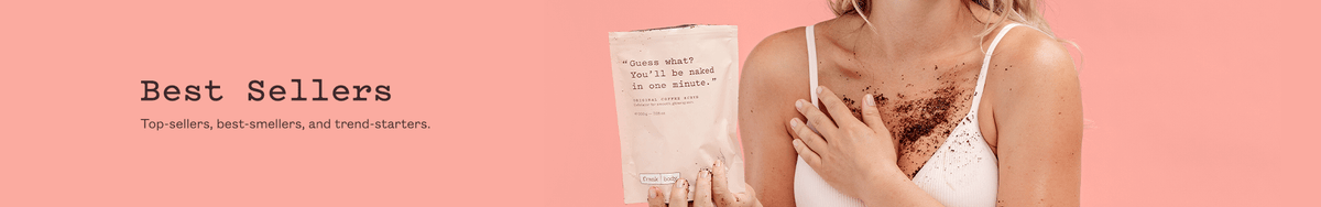Best Sellers collection banner. A smiling woman in a white bra holding a sachet of frank body Original Coffee Scrub, the scrub across her chest and stomach. Text reads: Best Sellers. Top-sellers, best-smellers, and trend-starters.