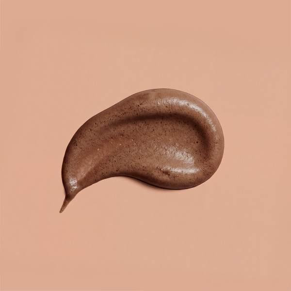 A swirl of brown frank body Firm + Glow Self Tan Mousse on a tan background.